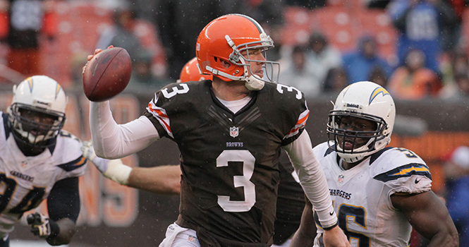 Cleveland Browns quarterback Brandon Weeden (3) rolls out of the pocket to throw a pass with San Diego Chargers linebacker Donald Butler in pursuit during the second quarter at Cleveland Browns Stadium in Cleveland, Ohio, Sunday, October 28, 2012. The Browns defeateed the Chargers, 7-6. Photo by PHIL MASTURZO
