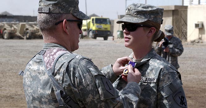 Col. Ricky Gibbs, commander, 4th Brigade Combat Team, 1st Infantry Division, Multi-National Division ? Baghdad, places a Purple Heart on the collar of Sgt. Jennifer Hunt, a civil affairs specialist assigned to Company A, 450th Civil Affairs Battalion (Airborne), 360th Civil Affairs Brigade (Airborne), for wounds suffered due to enemy contact during her deployment in support of Operation Iraqi Freedom. Staff Sgt. Jennifer Hunt, a civil affairs specialist in the Army Reserves, served in both Afghanistan and Iraq, where she was wounded by an roadside bomb in 2007. She is one of several servicewomen joining a lawsuit filed Tuesday, November 27, 2012, challenging the Pentagon's policy excluding women from combat positions. (MCT)