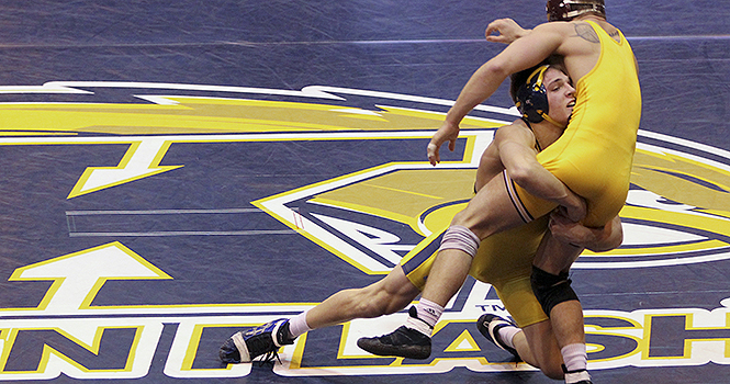 Freshman+Ian+Miller+wrestles+down+Central+Michigans+Joey+Kielbasa+during+Sundays+meet+at+the+M.A.C.+Center.+Miller+won+the+match+by+major+decision.+Kent+State+beat+Central+Michigan+22-13.+Photo+by+ANTHONY+VENCE.