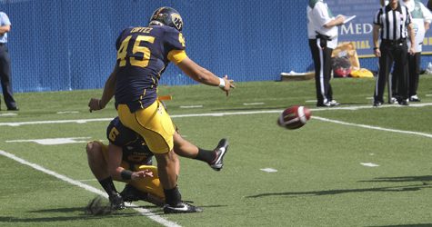 Freddy Cortez kicks against Ball State at Dix stadium on Sept. 29. The Flashes won the game 45-43. Photo by BRIAN SMITH.
