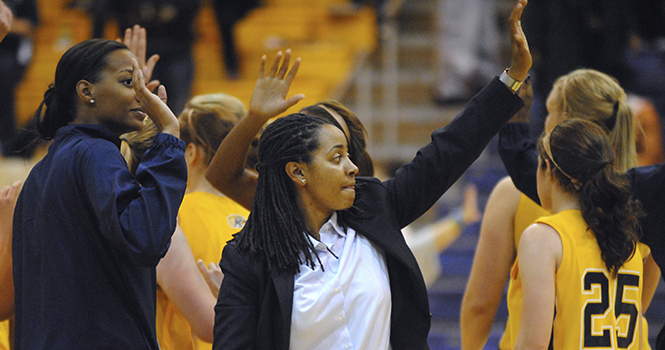 The new womens basketball head coach Danielle OBanion encourages the lady Flashes toward the end of their game against the Cincinnati Bearcats on Monday, Nov. 19. The Flashes lost with a final score of 59-41. Photo by Jenna Watson.