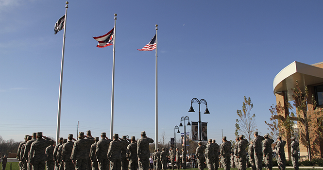 Kent State Army and Air Force ROTC students salute the raising of the United States, Ohio and POW/MIA flags during the annual KSU Veterans Day observance ceremony held Wednesday, Nov. 7 at Risman Plaza. Photo by Shane Flanigan.