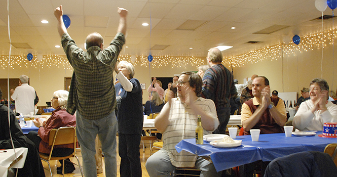 John Brovarone of Ravenna could not contain his excitement after hearing of another Obama winning another state while watching election coverage at the Italian American Society on Nov. 6. Photo by Grace Jelinek