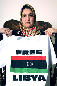 Libyan Education graduate student Amal Laba displays a shirt calling to free Libya Wednesday. Amal hopes to be able to return to her country and teach once she finishes her degree at Kent State University. Photo by Thomas Song.