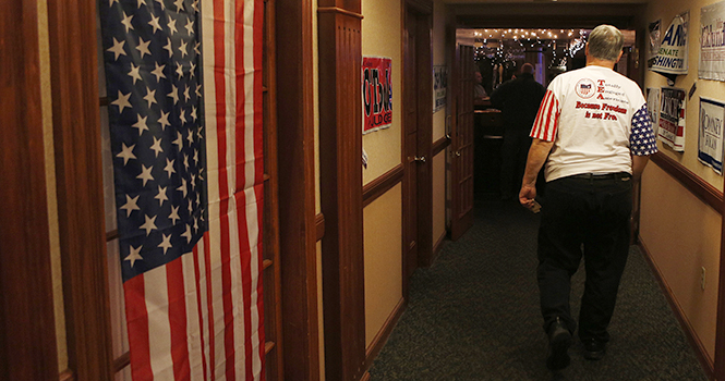 Bill Anderson, of Brimfield, walks down a hallway at The Fairways at Twinlakes during a Tea Party sponsored watch party for the 2012 Presidential Election on Tuesday, November 6, 2012. Photo Coty Giannelli.