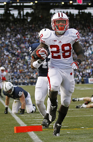 Wisconsin running back Montee Ball scores his NCAA record-setting touchdown on a 17-yard run against Penn State in the first quarter on Saturday, November 24, 2012, at Beaver Stadium in University Park, Pennsylvania. Balls score was the 79th of his career to set the new NCAA benchmark. Photo by courtesy of MCT Campus.