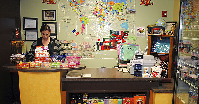 Colleen Belan works an evening shift at the International HOME Market in Acorn Alley on Tuesday, Nov. 27. Belan has been an employee there for about 10 months. The market is a student run business that has been successful through the Kent State entrepreneurship program. The market offers a variety of food and snacks from different cultures, and has been in business for about two years. Photo by Jenna Watson.