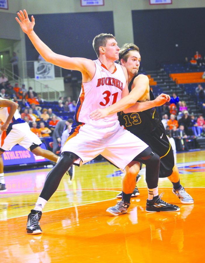 Kent State junior forward Mark Henniger defends Bucknell senior center Mike Muscala. The Flashes lost 76-60 Tuesday night at the Sojka Pavillion in Lewisburg, Pa. Photo courtesy of Todd Merrier and the Bucknell Athletic Department.