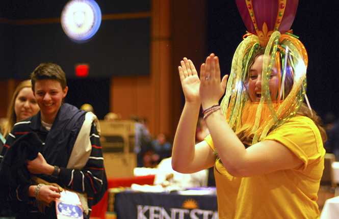 During the Festival of Nations on thursday, freshman fashion merchandising major Rachael Karlozi performs a Russian dance during a game of Russian Roulette while her friend, Nic Talbott, a sophomore sociology major, looks on. Photo by Melanie Nesteruk.