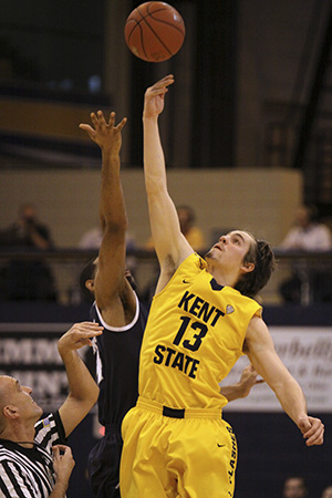 Sophomore forward Mark Henniger grabs for a jump ball at the beginning of the Akron game in the MAC center on Jan. 19. Kent State was defeated by Akron 71-67 during the televised Wagon Wheel game. Photo by STACY GRAHAM.