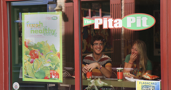 Freshmen Nick Hall and Brooke Boyd enjoy a meal together at The Pita Pit in Acorn Alley I September 8. Photo by Shane Flanigan.