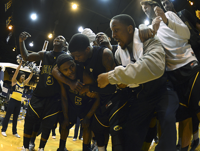The Kent State mens basketball team celebrates with Chris Evans after he made the winning basket in overtime against Buffalo on Wednesday, Feb. 27. The final score was 83-81. Photo by Jenna Watson.