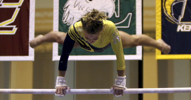 Kent State senior Lindsay Runyan recieved a score of 9.875 on the uneven bars in the gymnastics meet against George Washington and Western Michigan on January 25 2013. Photo by Melanie Nesteruk.