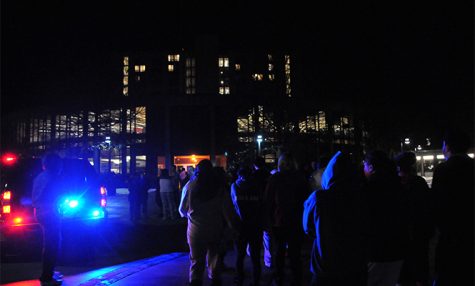 Students file back into the Rottunda of Tri-Towers after a small fire was detected on the eighth floor of Koonce Hall, causing the building to be evacuated around 2:45 a.m. on Friday, Feb. 8, 2013. Captain Moore of the Kent Fire Department said no injuries were reported, but the cause was still under investigation. Students were allowed back into the building after each floor was inspected and cleared about 45 minutes later. Photo by Jesse Denton.