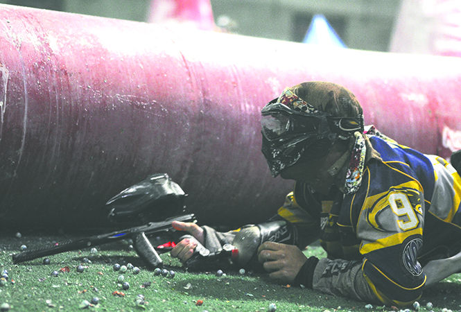 Adam Michl, accounting major, takes cover in the snake during a paintball battle on Monday, Feb. 25, 2013. Photo by JACOB BYK.