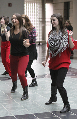 Students perform in a flash mob in Rockwell Hall for a worldwide cause called One Billion Uprising. The flash mobs are performed to increase awareness of abuse toward women. Photo by Stacy Graham.
