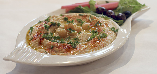 Lazizas Hummus is a popular Mediterranean-style appetizer made with pureed chick peas, fresh garlic, tahini sauce and lemon juice garnished with parsley and olive oil, January 18. Photo by Chelsae Ketchum.