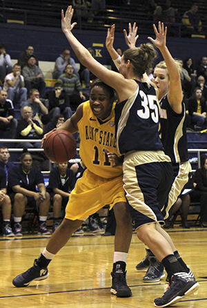 Senior forward Diamon Stubbs muscles her way through two defenders during a 77-71 home loss to Akron on Saturday, Feb. 23, 2013. The Akron Womens Basketball team completed its first sweep of Kent State in school history with the win. Photo by SHANE FLANIGAN.