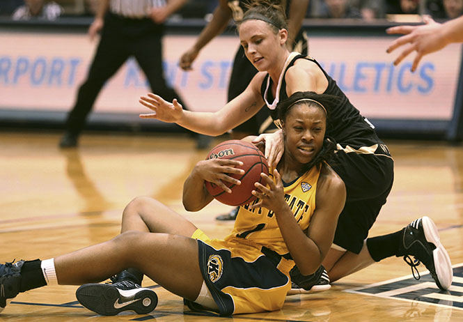 Freshman Ashley Evans keeps the keeps a loose ball from Western Michigan guard A.J. Johnson in the MAC Center on Feb. 7. The Lady Flashes fell to the Broncos 40-58. Photo by Brian Smith.