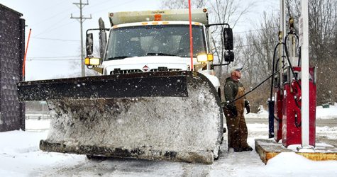 Former Kent city employee Matt Benson fills up his plow truck at the city garage on Jan. 13, 2012. Photo by Jake Byk.