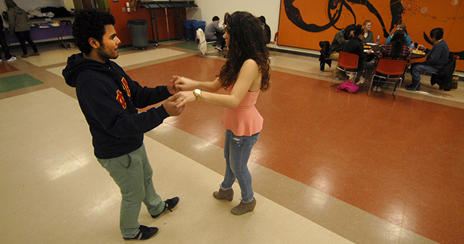 Karen Palma, sophomore fashion merchandising major, dances the salsa with Osmel Morales, on March 15. Photo by Jacob Byk.
