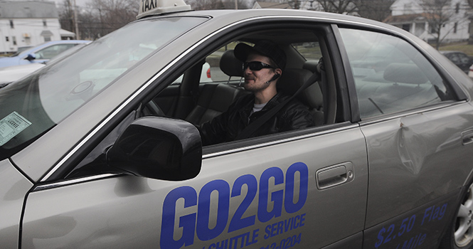 Keith Darling, Medina resident, returns from a run with Go2Go Taxi on March 7, 2013. He has been working for the cab company for a month. Photo by JACOB BYK.