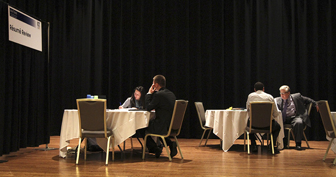 Students have their resumes reviewed by employers on the stage of the Student Center Ballroom during the IT Career Expo, March 14. Students could get feedback and ideas to better their resume as well as get tips for future interviews. Photo by Chelsae Ketchum.