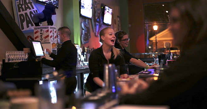 Ashleigh Grenfell of Streetsboro serves patrons at the soft opening at the Newdle Bar on South Water Street. Newdle Bar is a new bar that features top shelf sake and will have live music on Fridays. Photo by Brian Smith.