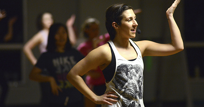 Senior sports administration major Jessica Szabo instructs students in a Zumba class in the Student Recreation and Wellness Center on Wednesday evening, March 13. Photo by Jenna Watson.