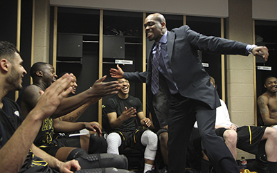 Assistant Coach DeAndre Haynes celebrates with the mens basketball team after their 70-68 victory over Buffalo in the MAC Tournament on Thursday, March 14 at Quicken Loans Arena in Cleveland. The win sets up a rematch with rival Akron in the semifinals Friday. Photo by Shane Flanigan.