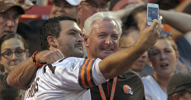Cleveland Browns owner Jimmy Haslam, right, poses for a picture with a Browns fan in the Dawg Pound during first-half action against the Philadelphia Eagles at Cleveland Browns Stadium in Cleveland, Ohio, Friday, August 24, 2012. (Ed Suba Jr./Akron Beacon Journal/MCT)