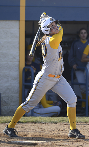 Freshman infielder Michele Duffy wtaches the ball as she follows through a swing for Kent State during a double header against University of Akron on Saturday, March 30. Kent State defeated Akron in both games, the first with a final score of 2-1 and the second with a final score of 5-3. Photo by Jenna Watson.