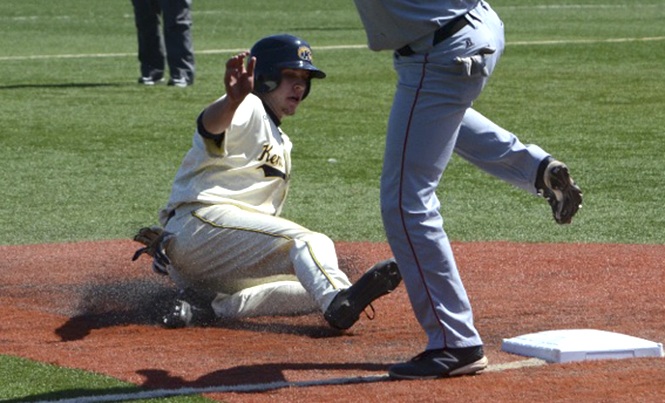Freshman Zarley Zalewski slides into third base during Kent States home game against Ball State on Saturday, March 30 at Schoonover Stadium. The Flashes won their first game with a final score of 11-5, but fell to Ball State in the second game, 4-3. Photo by Zane Lutz.