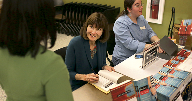 Jean Kilbourne signs copies of her books after giving a presentation in Oscar Ritche Hall on April 8. Kilbourne who is the author of ‘Killing Us Softly’, gave a presentation about how some advertisers use photo editing to objectify women in their work. Photo by Brian Smith.