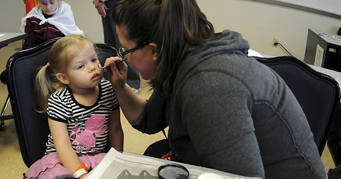 Mina Quade, 2, gets her face painted on Saturday April 20, 2013 as part of the events for Little Sibs Weekend. Photo by Rachael Le Goubin.