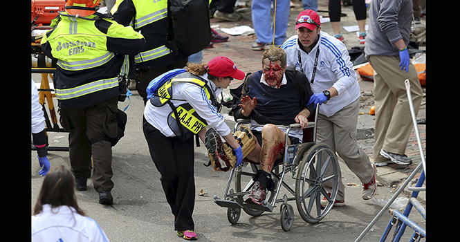 Medical+workers+aid+injured+people+at+the+2013+Boston+Marathon+following+an+explosion+in+Boston%2C+Monday%2C+April+15%2C+2013.+Two+explosions+shattered+the+euphoria+of+the+Boston+Marathon+finish+line+on+Monday%2C+sending+authorities+out+on+the+course+to+carry+off+the+injured+while+the+stragglers+were+rerouted+away+from+the+smoking+site+of+the+blasts.+%28AP+Photo%2FThe+Boston+Globe%2C+David+L+Ryan%29
