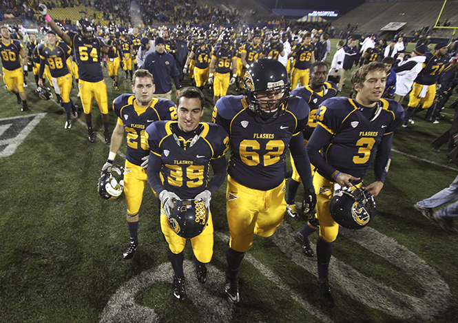 Members+of+the+Kent+State+football+team+run+across+the+field+after+winning+the+Homecoming+game+41-42+against+Western+Michigan+on+Oct.+20%2C+2012.+Photo+by+Brian+Smith.