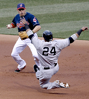 Cleveland Indians shortstop Astrubal Cabrera looks to avoid a sliding New York Yankees Robinson Cano on a double play in the first inning at Progressive Field on Tuesday, April 9, 2013, in Cleveland, Ohio. (Phil Masturzo/Akron Beacon Journal/MCT)