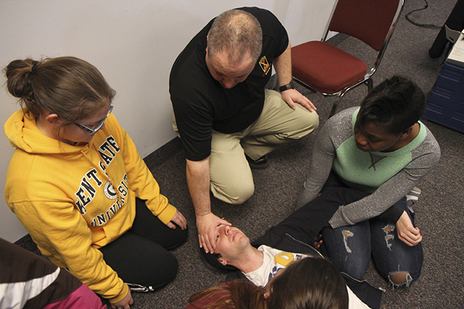 Lt. Joe Hendry of the KSUPD demonstrates to students how to detain a gunman during the A.L.i.C.E. training workshop on March 15, 2013 in the student center. A.L.I.C.E., which stands for Alert, Lockdown, Information, Counter and Evacuation, is a crisis training program teaching students how to deal with an active shooter situation. Photo by Shane Flanigan.