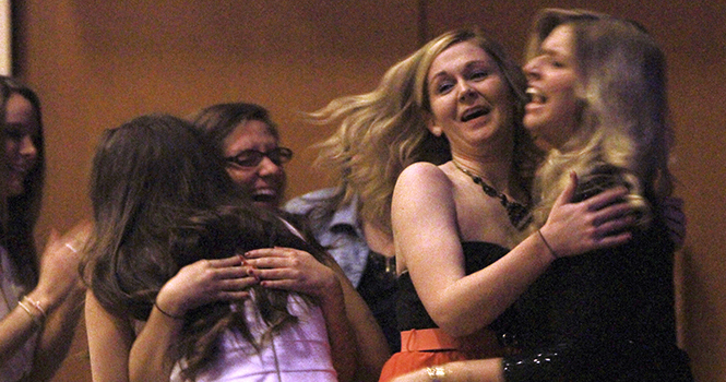 Members of Alpha Xi Delta hug each after hearing that they have been awarded the Sorority of the Year. They were at the 2013 Fraternity and Sorority Awards in the Student Center Ballroom on April 30, 2013. Photo by Yolanda Li.