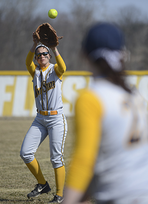 Kent State softball players warm up before their game on March 30, 2013. . Photo by Jenna Watson.