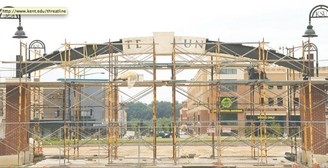 After material replacements, construction workers begin to mount stone letters along the arch above the Esplanade extension on Monday, July 22, 2013. Photo by Yolanda Li.