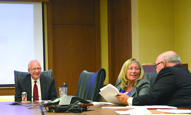 Lestor Lefton, President of Kent State University, Stephen Colecchi, chairperson for Board of Trustees Finance Committee and Charlene Reed, secretary to the Board of Trustees talk during a board meeting which approved a request to begin construction for College of Applied Engineering and Sustainability.Photo By Jacob Byk.