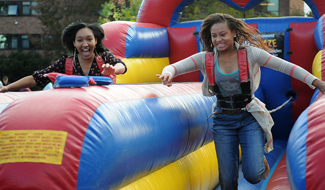 Freshman+Broadcast+Journalism+majors+Khaliah+Shafeeq+%28left%29+and+Raven+Fulton+%28right%29+compete+in+an+inflatable+game+at+Quadfest+on+Wednesday+Sept.+25%2C+2013.+Photo+by+Rachael+Le+Goubin.
