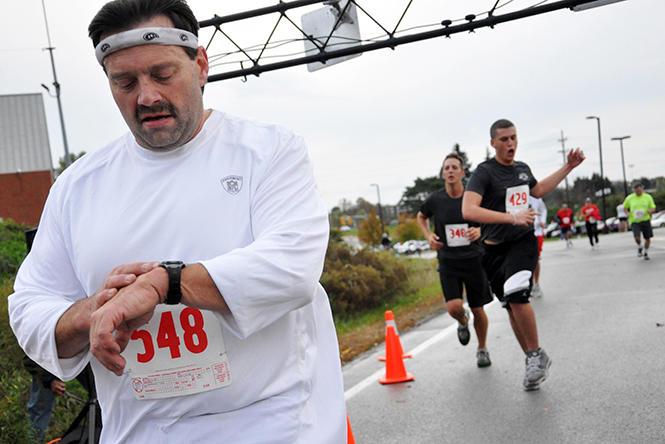 Participant Ralph Reafer stops his timer after finishing the Bowman Cup 5k Saturday, Oct. 15, 2011. This years Bowman Cup 5K will be held this Saturday, Oct. 5, 2013 at 8 a.m. Photo by Megann Galehouse.
