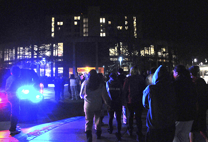 Students file back into the Rottunda of Tri-Towers after a hand sanitizer dispenser caught fire on the eighth floor of Koonce Hall, requiring students to evacuate around 3 a.m. February 8, 2013. Drills are held regularly to ensure students safety in case of emergencies such as this.. Photo by Jessica Denton.