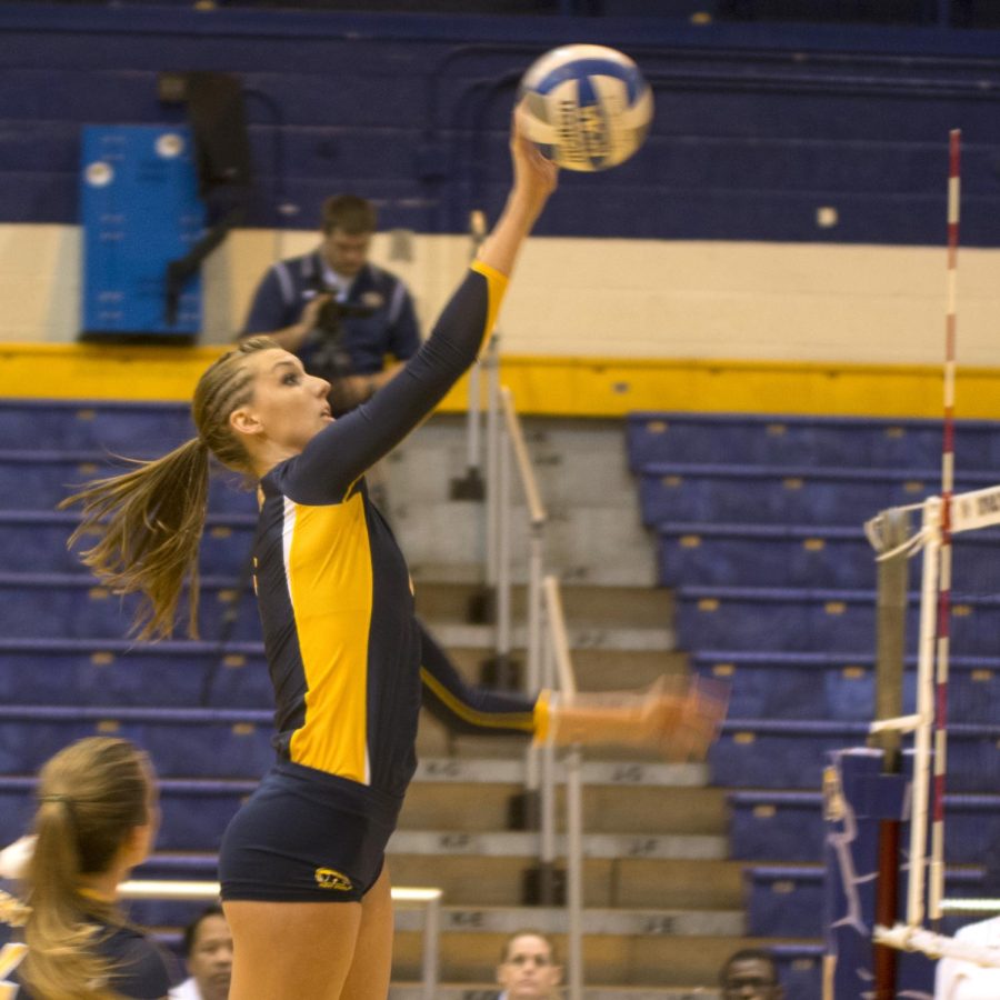 Number nine; Liz Reikow; spikes the ball to get the point on August 21; 2013. Kent Volleyball Team won their match against Eastern Illinois. Photo by Abby Schafer.