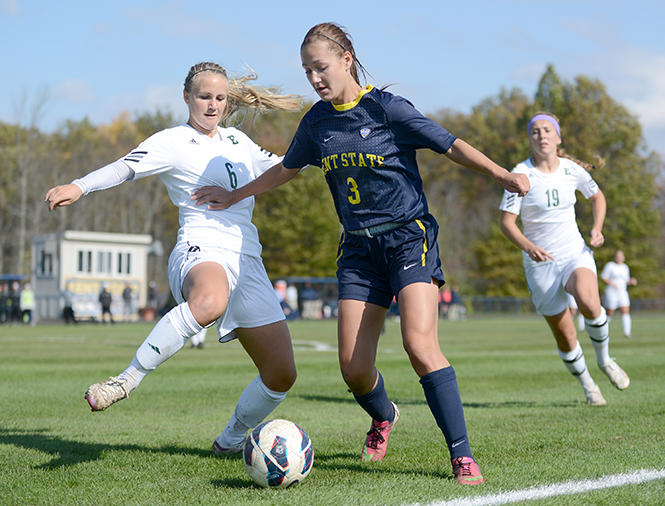 Junior forward Stephanie Haugh (center) prepares to take a shot at the goal, to no avail, as Kent State fell to Eastern Michigan University on Sunday, Oct. 20, 2013, a final score of 2-0. Photo by Jenna Watson.