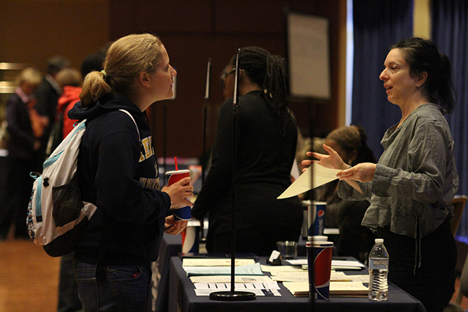 Freshman special education major Cari Pierce talks with Gina Zavota about philosophy at the Majors Fair in the Student Center Ballroom on Tuesday, Oct. 8, 2013. Photo by Chelsae Ketchum.