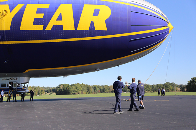 Ground crew members of the Spirit of Goodyear help steady the blimp after it landed in Suffield Township on Wednesday, Oct. 9, 2013. Photo by Brian Smith.